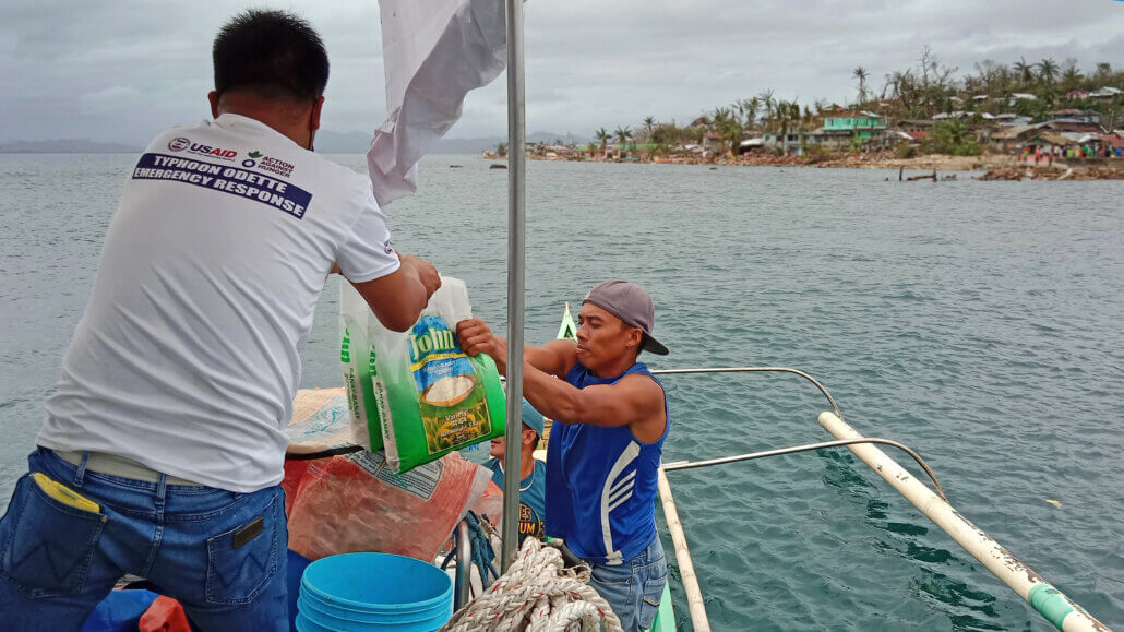 Action Against Hunger team loads relief items to boats going to the island barangays of Talisay, Surigao Del Norte